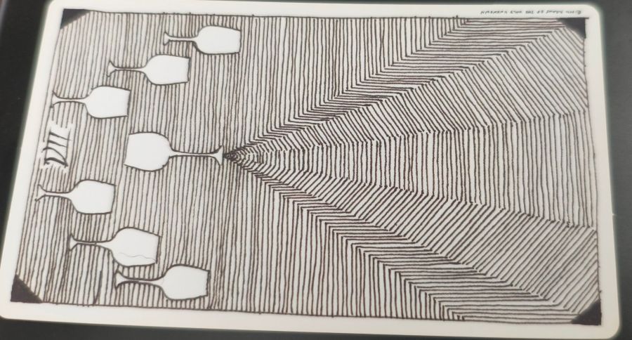 The Seven of Cups from the Wild Unknown Tarot, turned sideways to show the seven cups on the left, with one cup showing a triangle-shaped field extending from it.